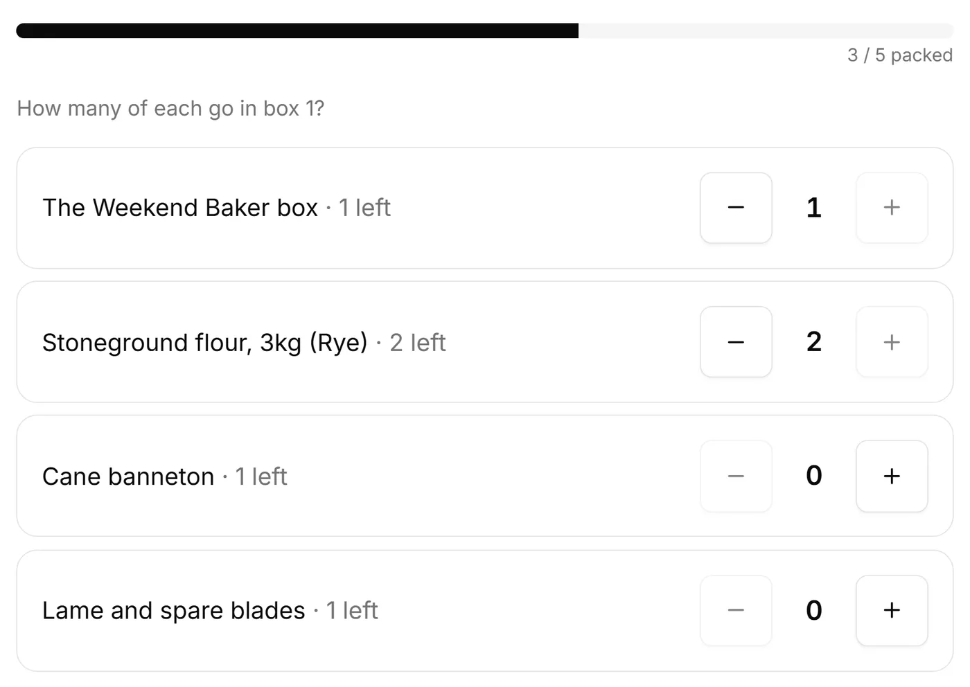Packing an order for a demo bakery: 3 of 5 items packed, the Weekend Baker box and 2 rye flours in box 1, the banneton and blades still to go